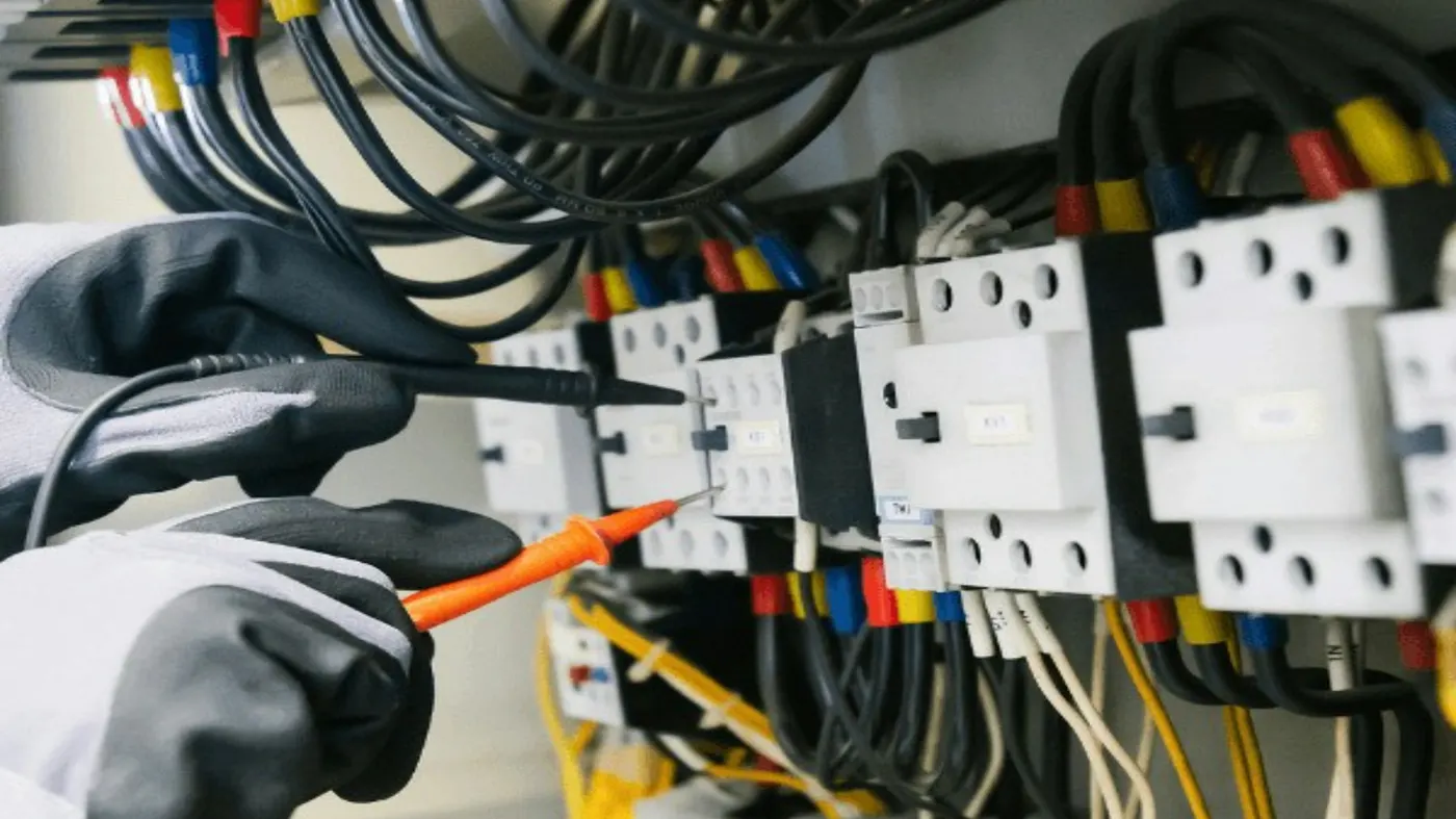 Electrician carrying out an EICR on a domestic consumer unit